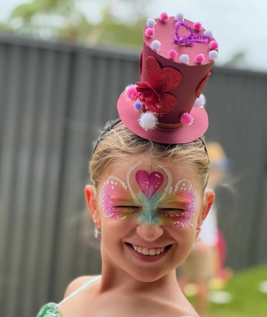 Child with colorful professional face painter in Sydney.