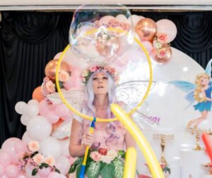 Fairy blowing bubble with flower background